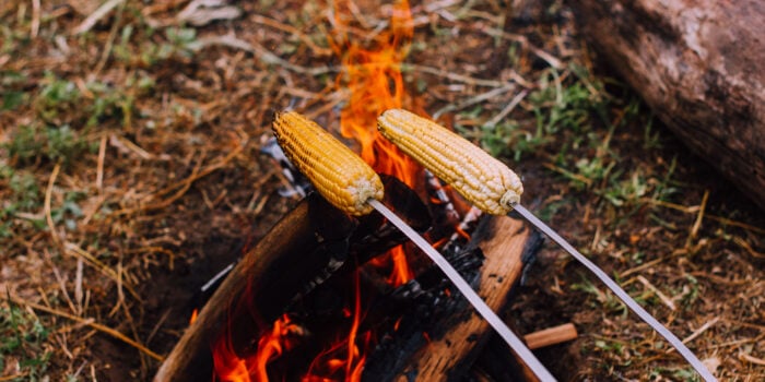 corn over fire, feature image for best way to cook corn on the cob
