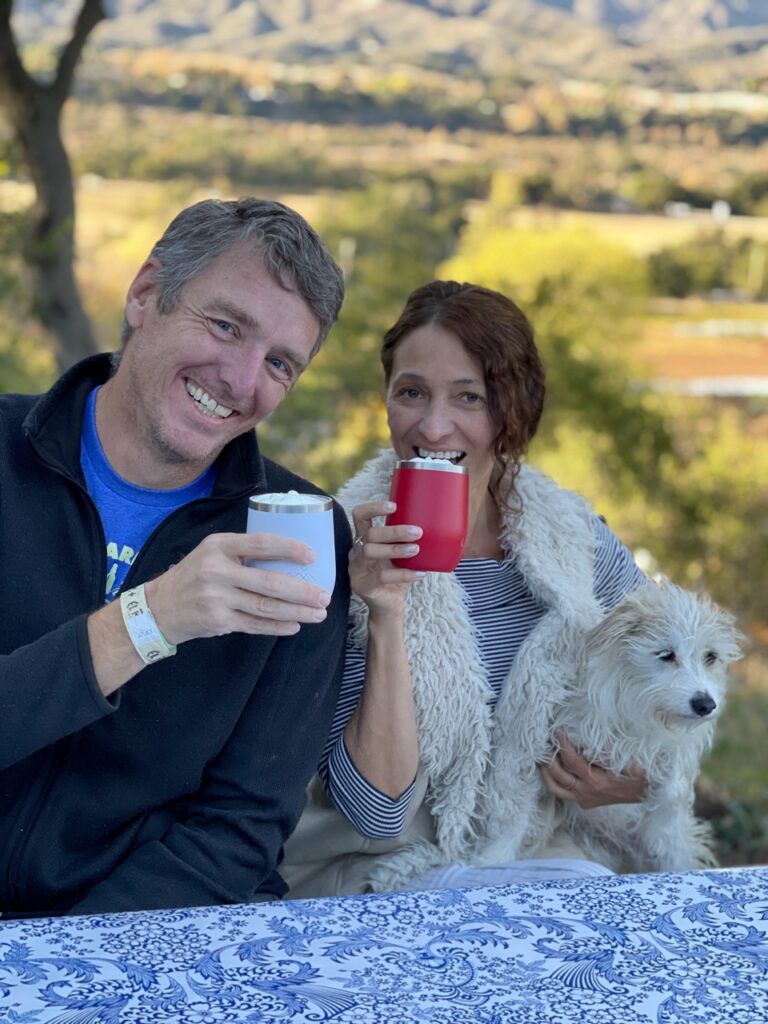 Couple enjoys drinks from wine tumblers