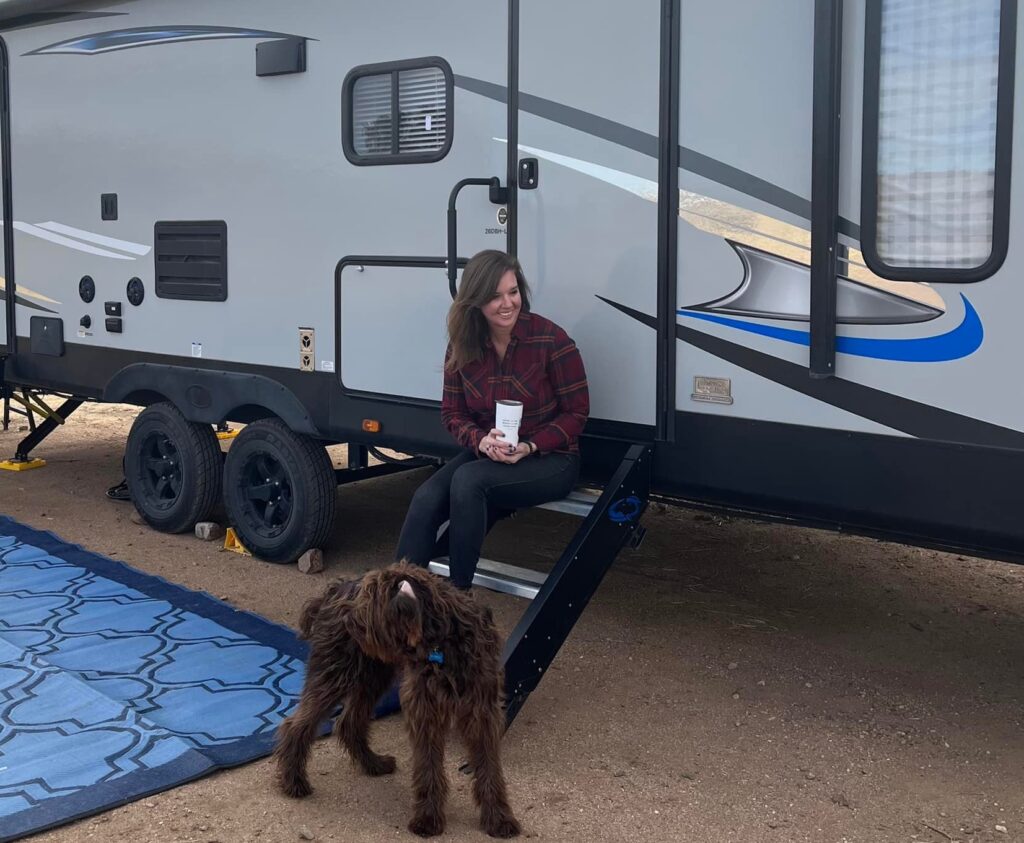 Kimberly Crossland and her dog in front of her RV