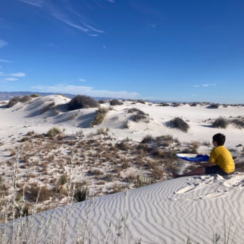 Boy sitting in sand at White Sands