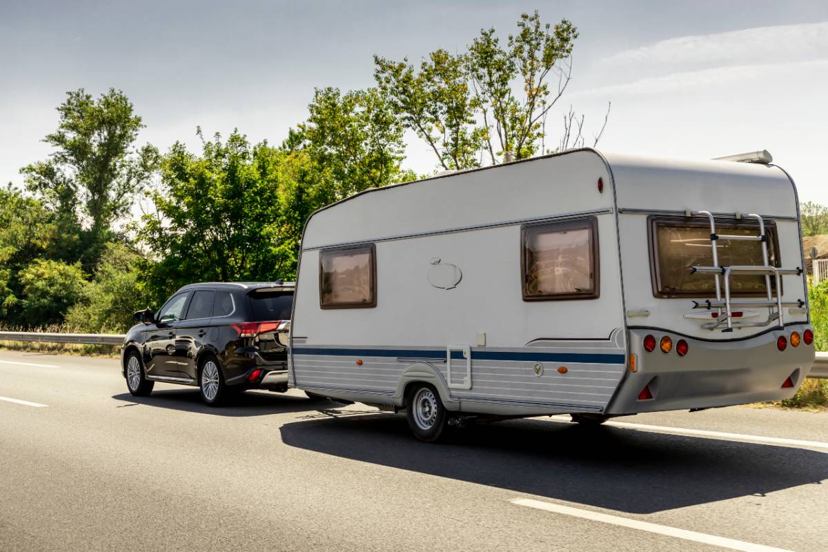 Caravan trailer on a freeway road. Do you have RV towing insurance?