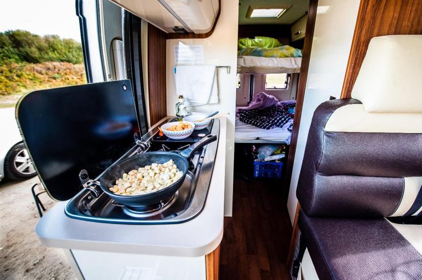 cooking food in a van - feature image for common myths about RVing