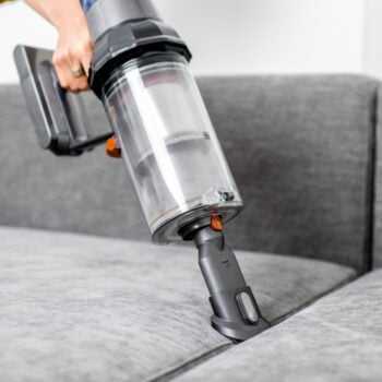 cordless vacuum being used to vacuum upholstery