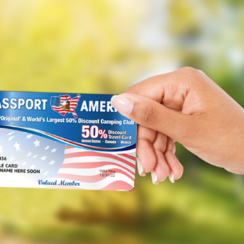 a hand holds a passport america membership card