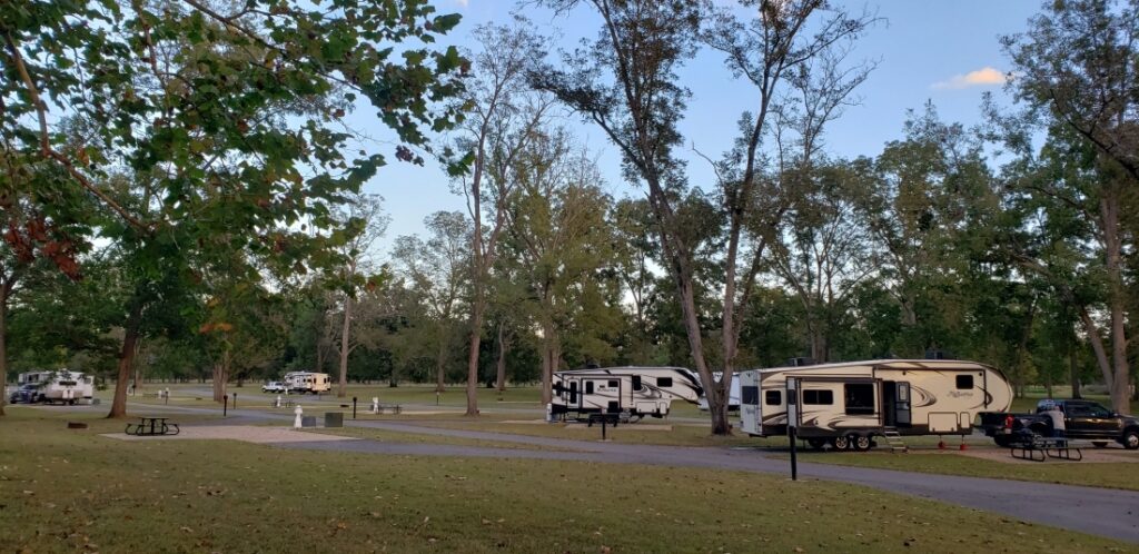 Fifth-wheel trailers camping at Grand Ecore RV Park.