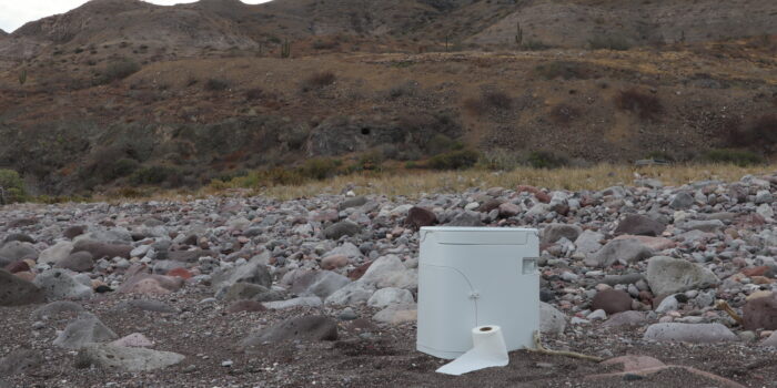 OGO Composting Toilet on a rocky beach