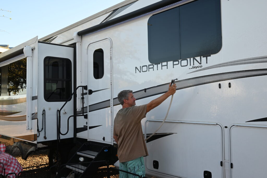 person washing rv, image for wash your rv at a campground