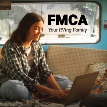 young woman in rv explores FMCA benefits on laptop