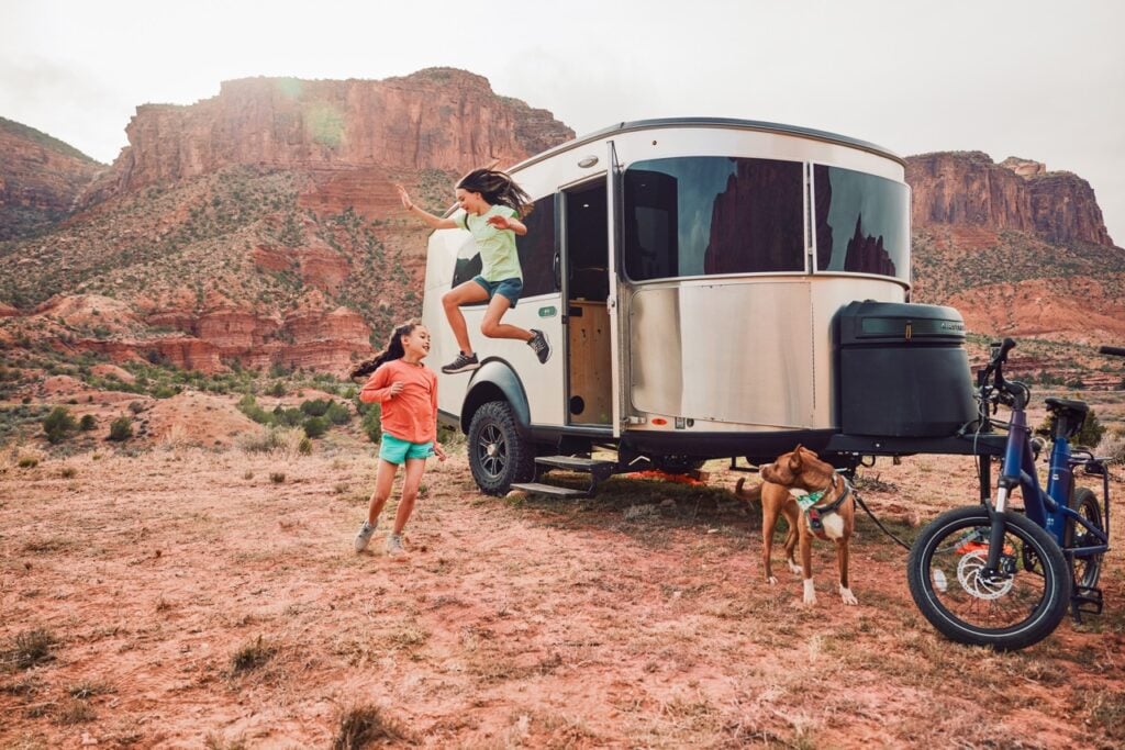 Kids playing in front of Airstream Basecamp lightweight travel trailer.
photo: Airstream