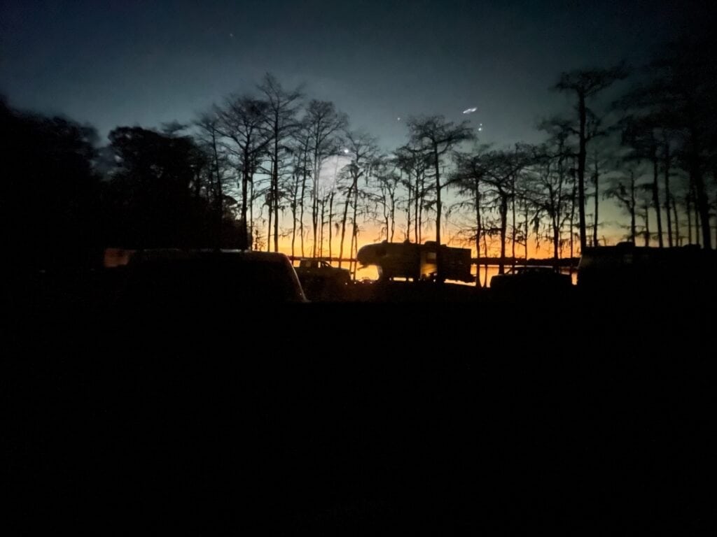 A nighttime shot of a fifth-wheel in a site at top-rated Lake Jackson RV Campground.