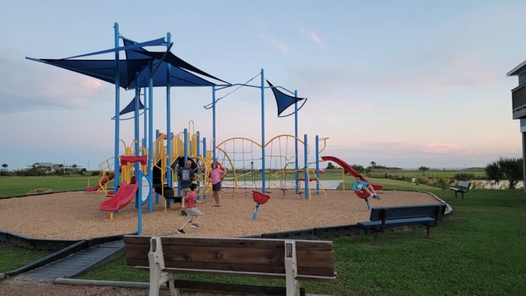 Two children on a playground at Stella Mare RV Resort.