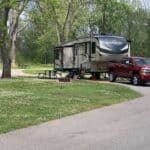 A fifth-wheel and truck camping at Ecore RV Park in Louisiana.