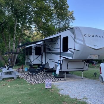 Fifth-wheel in a campsite at Piney River RV Resort.