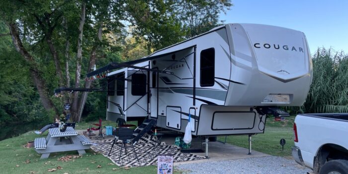 Fifth-wheel in a campsite at Piney River RV Resort.