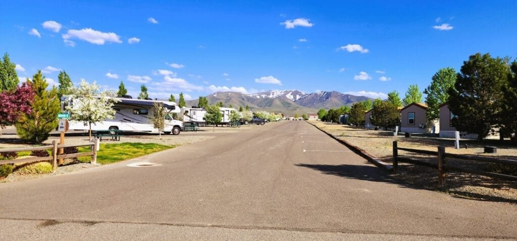 An interior road at the top-rated RV campground, New Frontier RV Park, showing RV sites on both sides and a Class C motorhome.