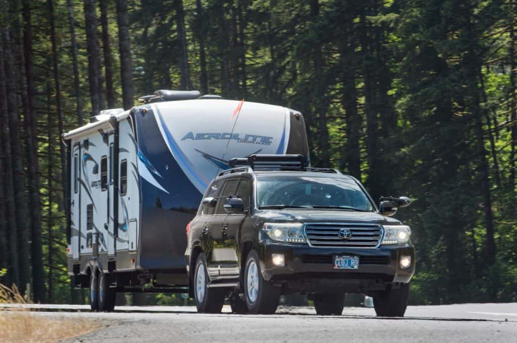 A Toyota SUV towing a lightweight trailer on a mountain road. Photo: Bruce W. Smith.
