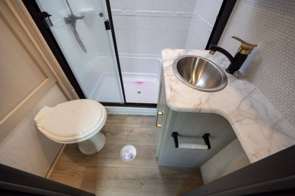A photo of an RV bathroom, showing a toilet, sink, and shower enclosure. Photo: Bruce W. Smith