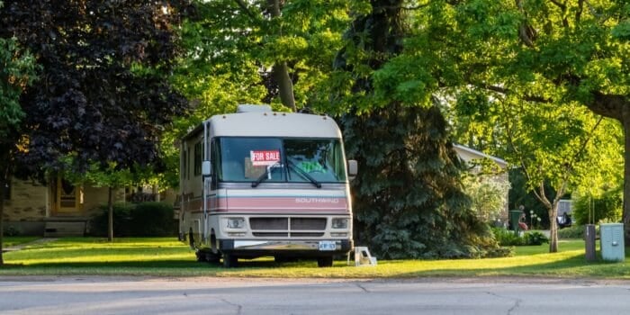 RV in yard with for sale sign in window