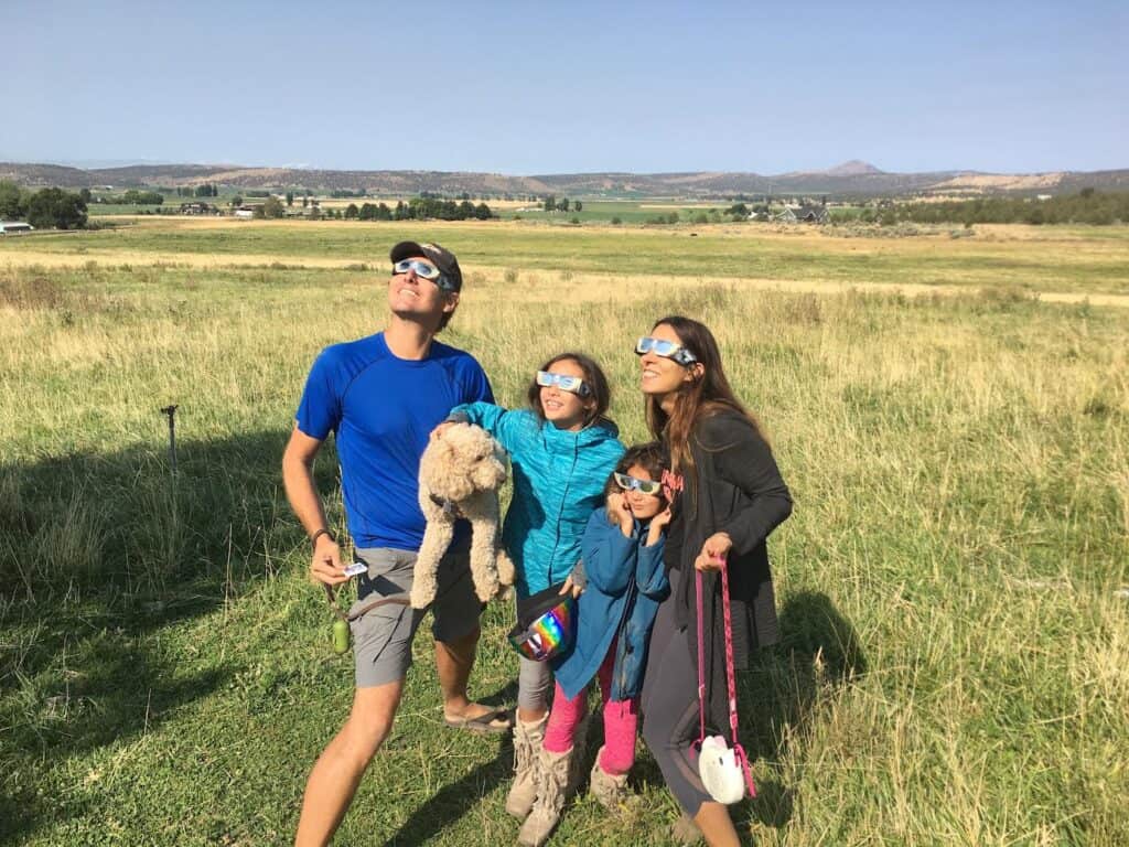 The author and her family viewing the 2017 solar eclipse with glasses on. Photo: Carol Carimi Acutt.